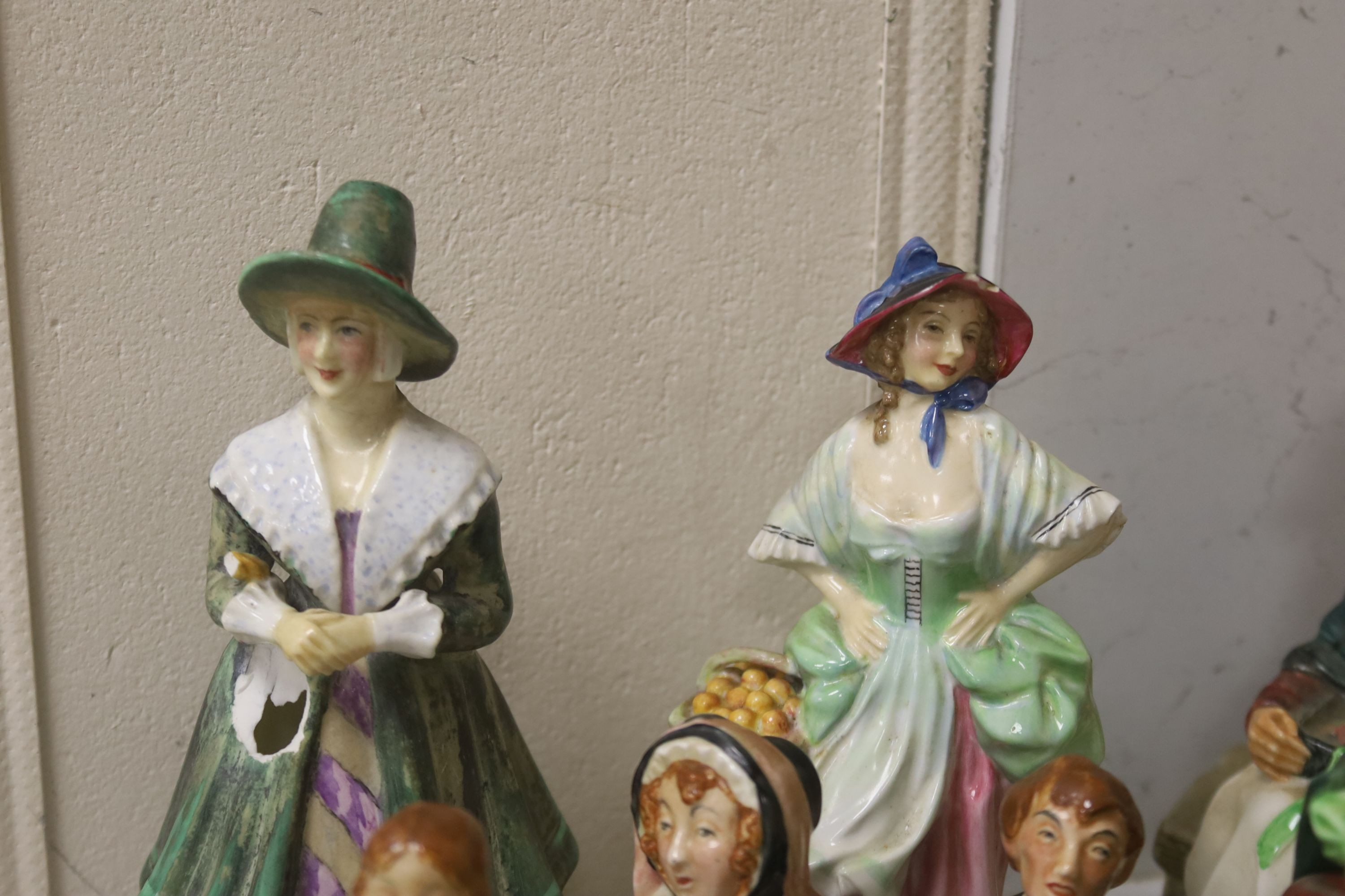 A group of 12 Royal Doulton figures and four plates